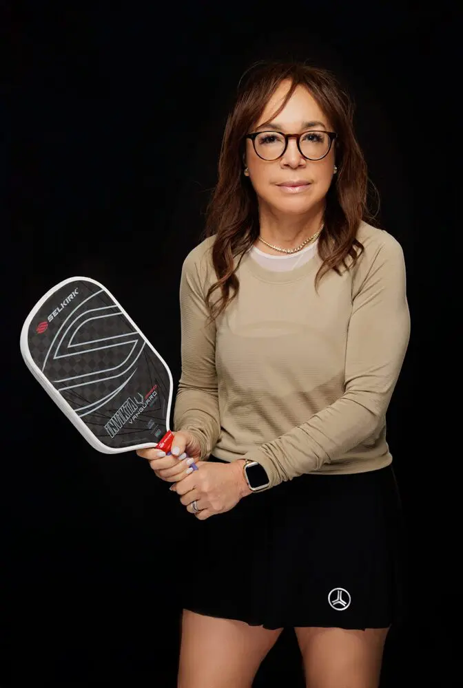 A woman holding a racket in her hand.